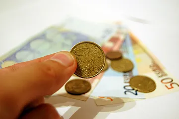 Hand holding a coin from 4freephotos.com